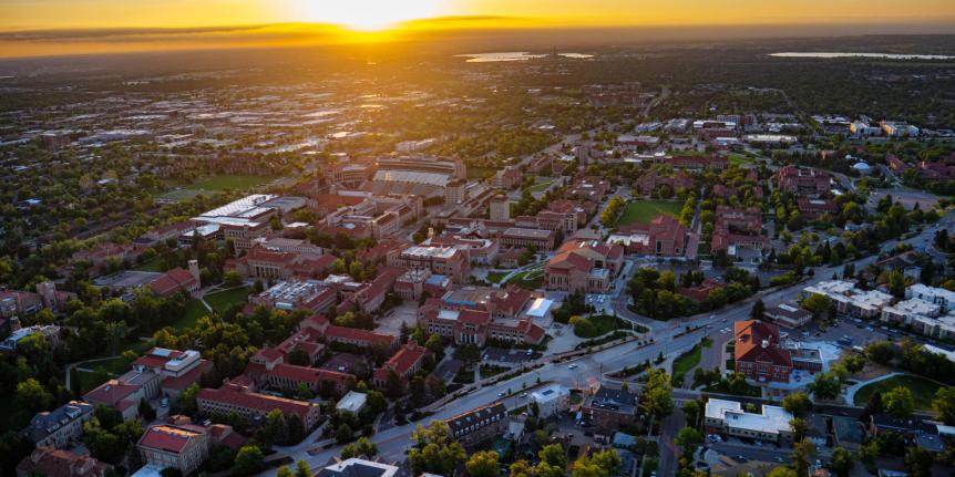 decorative image of sunrise over campus aerial view