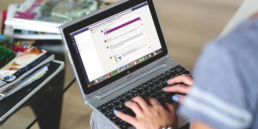 A woman uses Microsoft Teams on her laptop computer.
