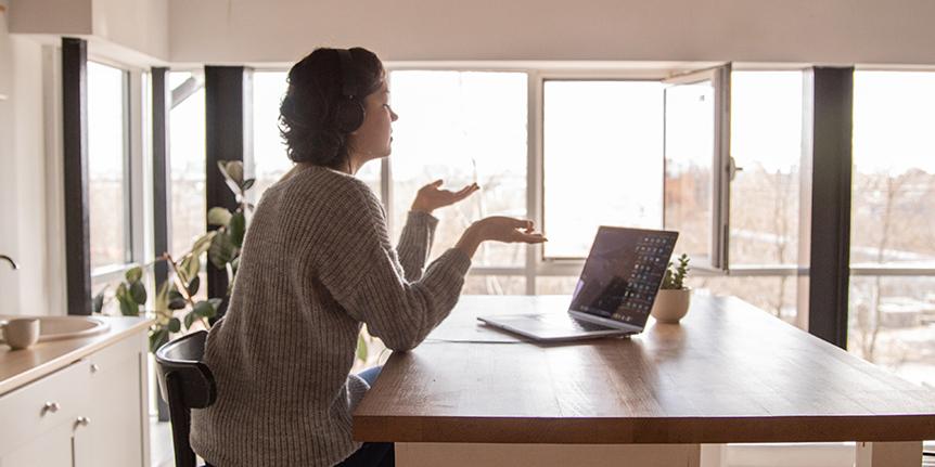 Woman working on laptop in kitchen