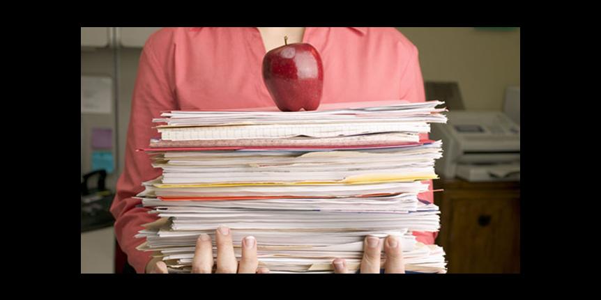 Decorative photo: stack of papers with an apple on top.
