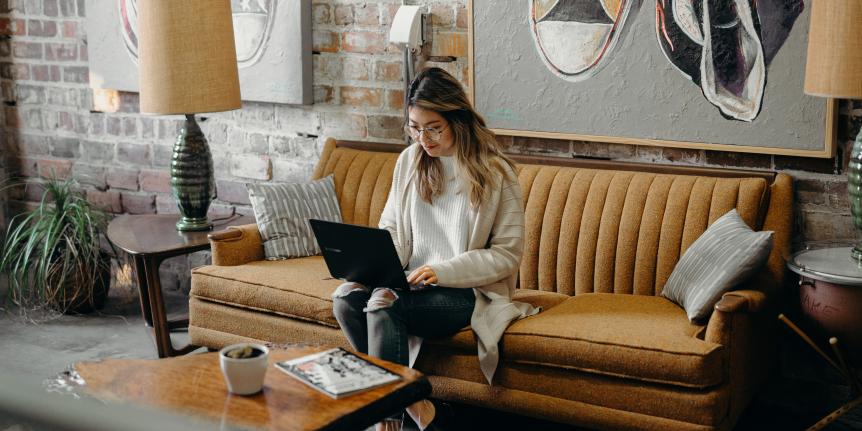 Person sitting on a couch with their computer