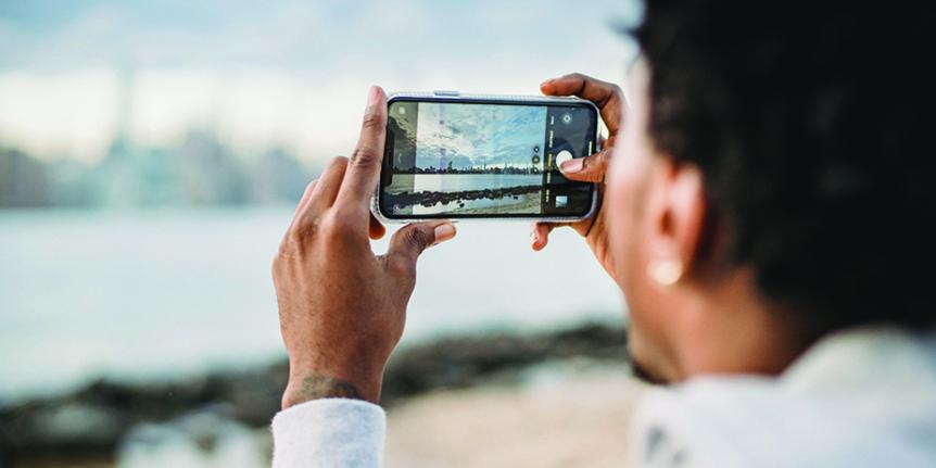 man takes picture with phone