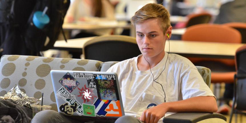 Student on laptop computer in library