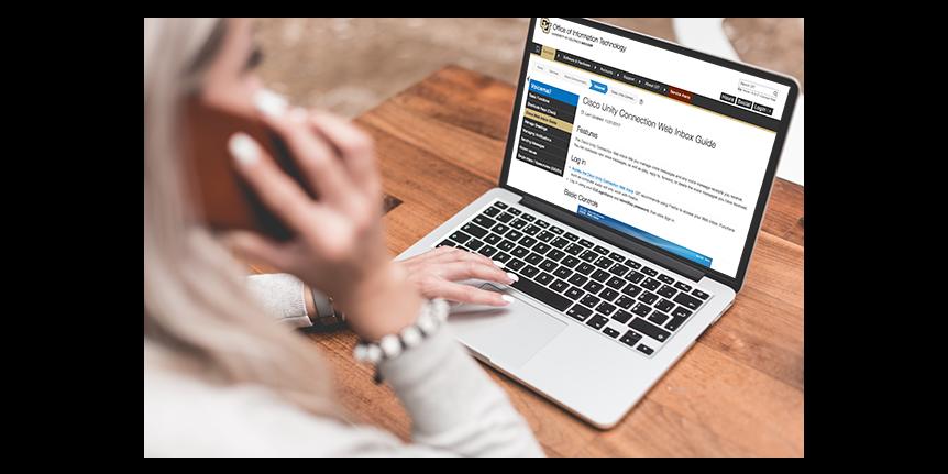 woman on the phone while looking at Cisco Unity Web Inbox page 