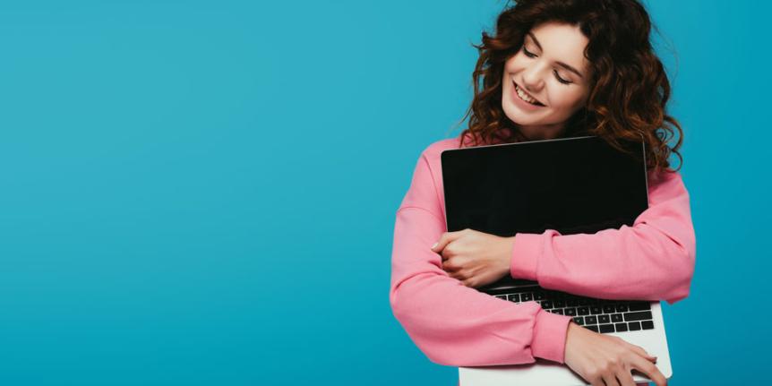 Someone hugging a laptop computer.