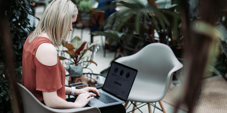 A woman working on a laptop.